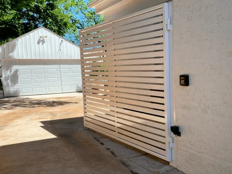 Springfield Automatic Driveway Gate Installation Services | VectorFence.com Modern white automatic driveway gate with keypad access installed to represent Vector Fence services.