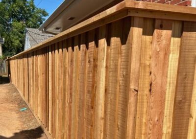 Board-on-board cedar fence with cap and trim showcasing Vector Fence’s residential wood fence installation services.