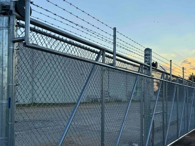 Commercial Cantilever Automated Gate Installation Services | Vector Fence Commercial cantilever automated gate with barbed wire security top, showcasing a durable, high-security access solution for industrial properties in Springfield, MO.