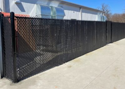 Commercial chain link fence installation with privacy slats showcasing the secure and durable fencing solutions provided by Vector Fence.