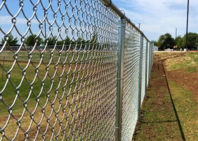 Galvanized commercial chain link fence installation showcasing the durable perimeter fencing solutions offered by Vector Fence.