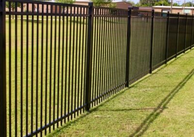 Commercial ornamental iron fence installation providing strong perimeter security and a clean, professional appearance.