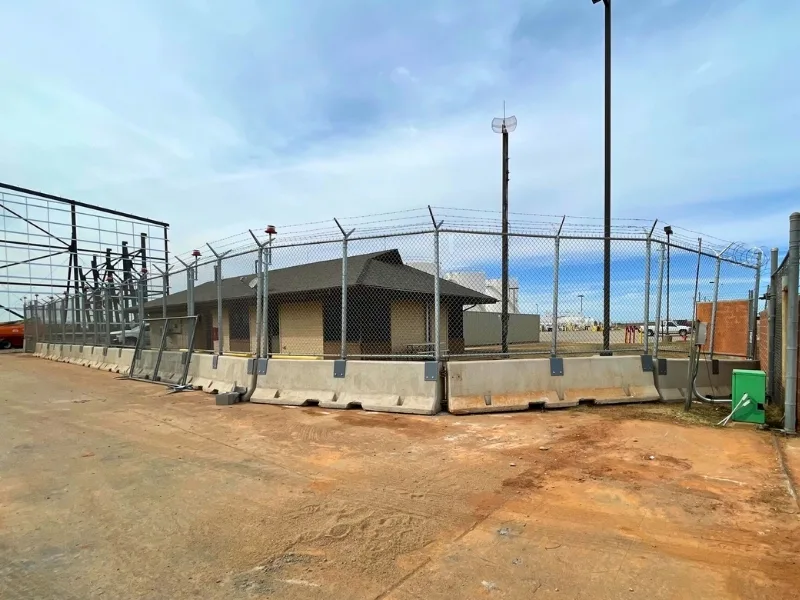 AOA Temporary Fence Panel Entrance Installation | Vector Fence AOA temporary fence panels installed with concrete barriers and angled security extensions, controlling access at an aircraft operations area.