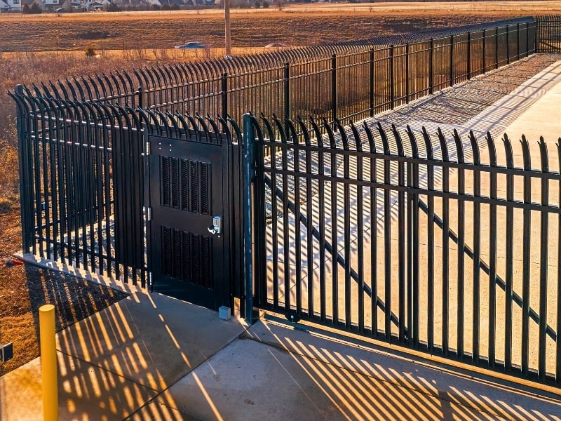 High-security walk-through gate and automated steel gate installation with anti-climb design, showcasing what can be installed for secure commercial facilities.