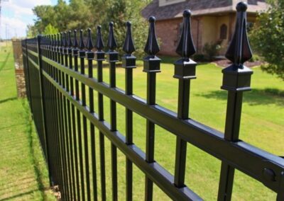 Black ornamental iron fence highlighting Vector Fence’s ornamental iron installation services.