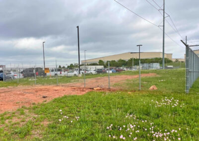 Post-driven temporary chain-link fence installed around a commercial site, providing secure and stable perimeter control for a long-term project.