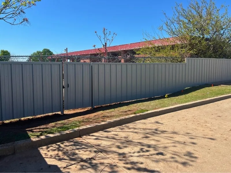 R-Panel Metal Fence Installation Services in Springfield, MO | VectorFence.com R-panel metal privacy fence highlighting Vector Fence’s metal fence installation services available in Springfield, Missouri.