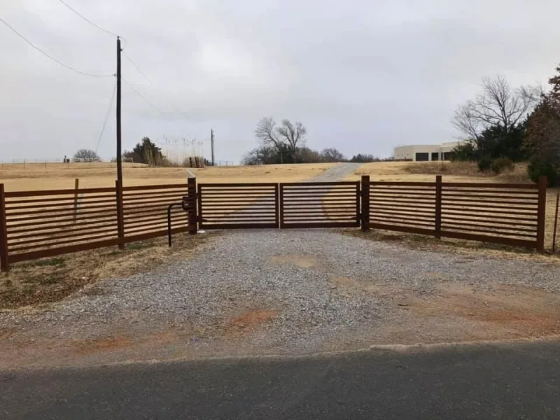Rural Automatic Driveway Gate Installation Services in Springfield | Vector Fence Rural automatic driveway gate with horizontal steel slats and matching fence line, showcasing a durable and stylish access solution for country properties.