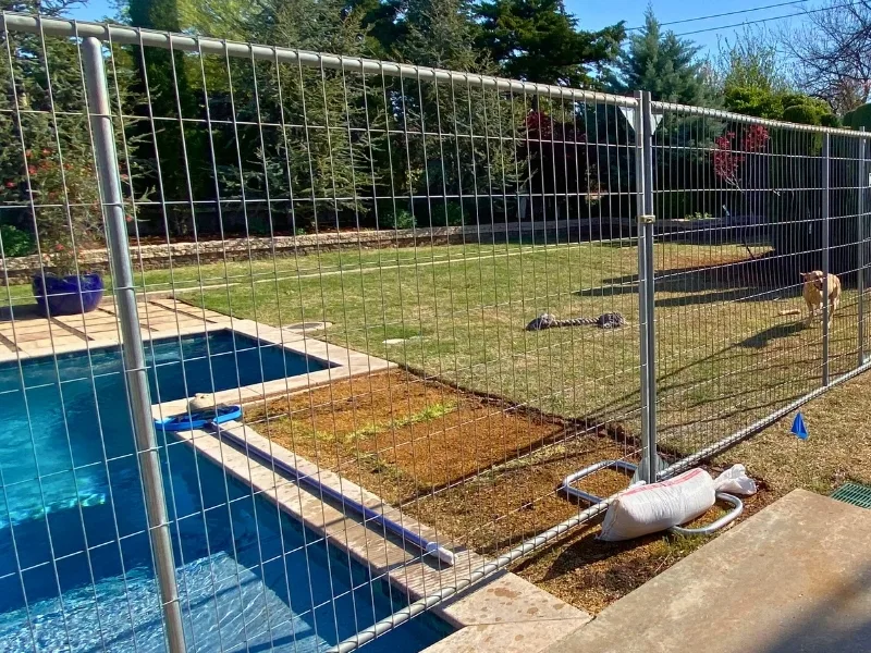 Temporary Fence Separating Residential Backyards | Vector Fence Temporary fence panels installed between residential backyards to create a safe barrier around a pool and separate adjoining properties.