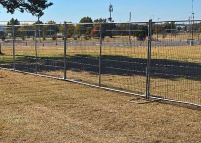 Commercial temporary fence panels installed on an open site, providing secure perimeter control for construction, events, or short-term projects.