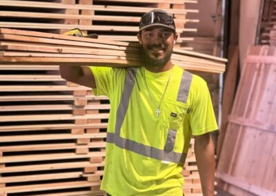 Vector Fence team member handling premium wood fence materials, showcasing skilled craftsmanship and professional installation standards.