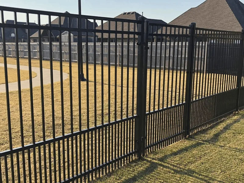 Ornamental Iron Fence Installation Services | Vectorfence.com Black ornamental iron fence with puppy panel installed around a residential property by Vector Fence.