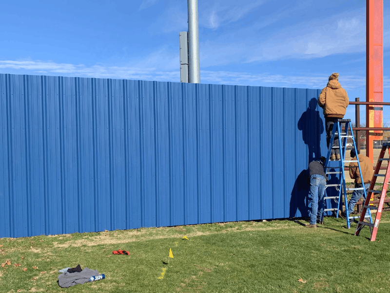 Blue Corrugated Metal Privacy Fence | VectorFence.com Blue corrugated metal privacy fence installed with vertical panels for secure screening and a clean finished look.
