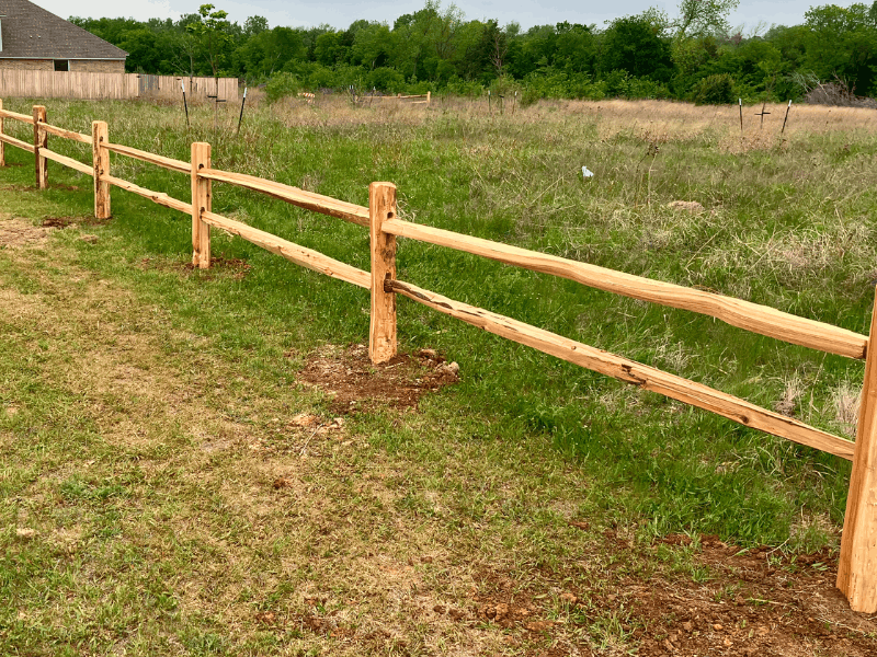 2 Rail Cedar Split Rail Fence Installation | VectorFence.com Two rail cedar split rail fence installed by Vector Fence along an open property line for natural curb appeal and boundary definition.