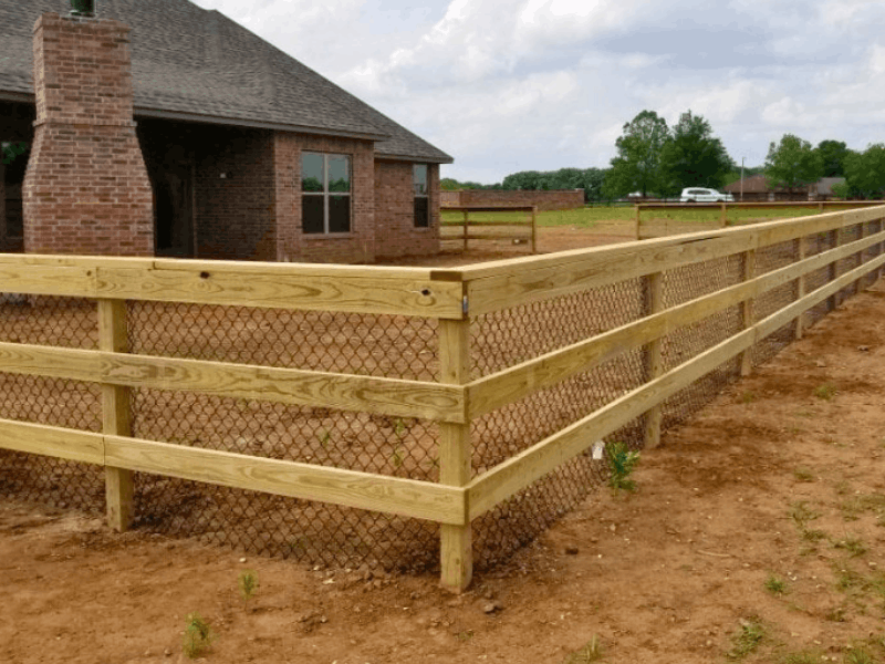Post and Rail with Chain Link Fence | VectorFence.com Post and rail fence with chain link backing installed around a residential property for added containment and open visibility.