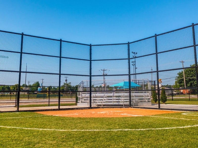 Sports Facility Chain Link Fence | VectorFence.com Tall chain link fence installed around a sports field to help protect players, spectators, and athletic facility boundaries.