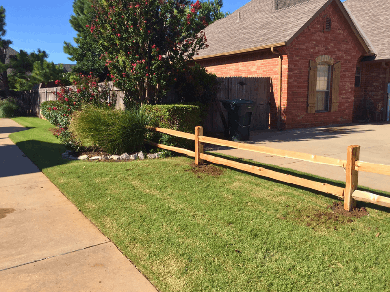 Two Rail Cedar Split Rail Fence | VectorFence.com Two rail cedar split rail fence installed along a residential front yard for a simple open boundary and natural curb appeal.